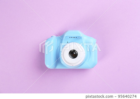 Light blue toy camera on pink background, top view Light blue toy camera on pink background, top view 95640274