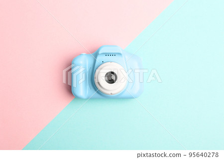 Light blue toy camera on color background, top view. Future photographer Light blue toy camera on color background, top view. Future photographer 95640278