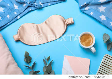 Flat lay composition with sleeping mask on light blue background. Bedtime accessories Flat lay composition with sleeping mask on light blue background. Bedtime accessories 95640308