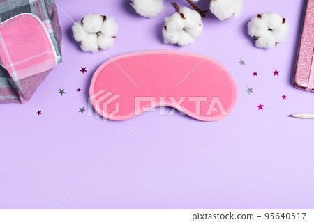 Flat lay composition with sleeping mask on violet background, space for text. Bedtime accessory Flat lay composition with sleeping mask on violet background, space for text. Bedtime accessory 95640317