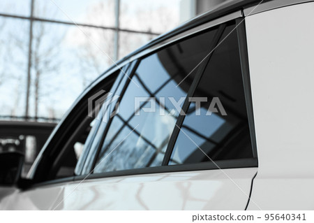 Modern car with tinting foil on window, closeup 95640341