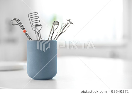 Set of different logopedic probes in holder on light table, space for text. Speech therapist's tools Set of different logopedic probes in holder on light table, space for text. Speech therapist's tools 95640371