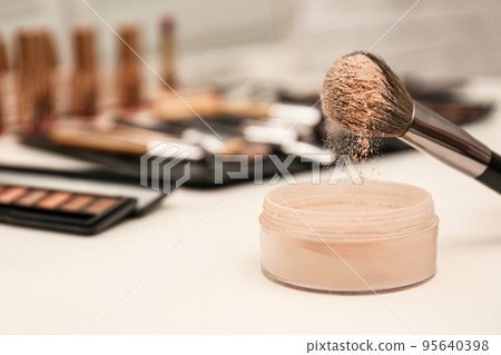 Professional brush of makeup artist and powder on dressing table 95640398