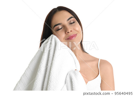 Young woman wiping face with towel on white background Young woman wiping face with towel on white background 95640495