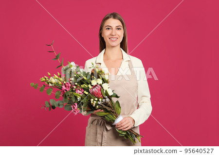 Florist with beautiful bouquet on pink background Florist with beautiful bouquet on pink background 95640527