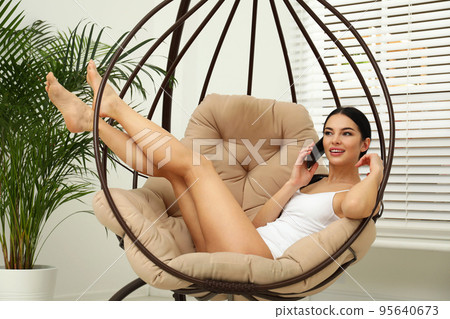 Beautiful young woman in white underwear talking on phone at home Beautiful young woman in white underwear talking on phone at home 95640673