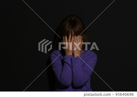 Abused little girl showing with phrase HELP ME near blue wall, focus on hand. 95640696