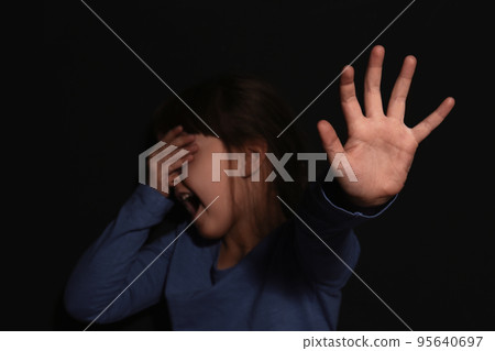 Abused little girl showing with phrase HELP ME near blue wall, focus on hand. Abused little girl showing with phrase HELP ME near blue wall, focus on hand. 95640697