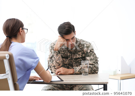 Psychotherapist working with male military officer in office 95641070