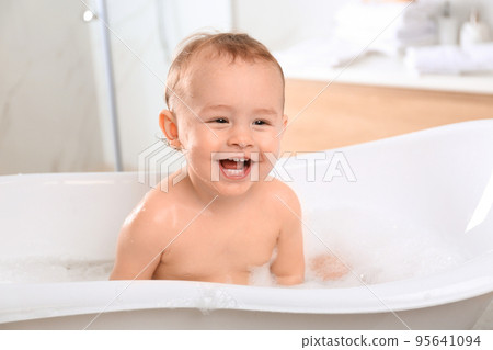 Cute little baby in bathtub at home 95641094