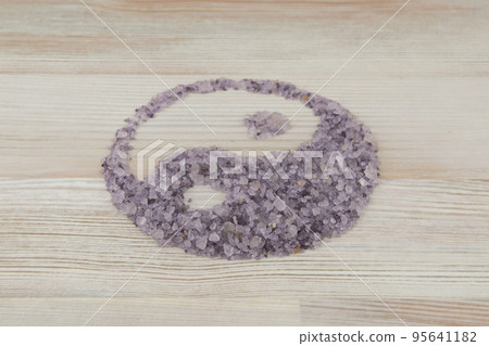 the sign of Yin-Yang was built with a natural aromatic sea bath salts on a white table, a horizontal arrangement the sign of Yin-Yang was built with a natural aromatic sea bath salts on a white table, a horizontal arrangement 95641182