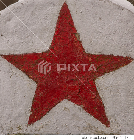 red star on the monument to Soviet soldiers, the old paint is cracked and faded red star on the monument to Soviet soldiers, the old paint is cracked and faded 95641183