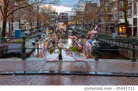 Beautiful old houses on the city waterfront of Amsterdam at sunset. 95641721