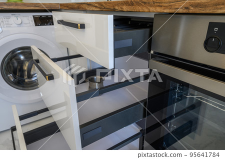 White and wooden modern kitchen furniture, some drawers open White and wooden modern kitchen furniture, some drawers open 95641784