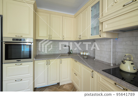 Interior of modern trendy cream colored kitchen Interior of modern trendy cream colored kitchen 95641789
