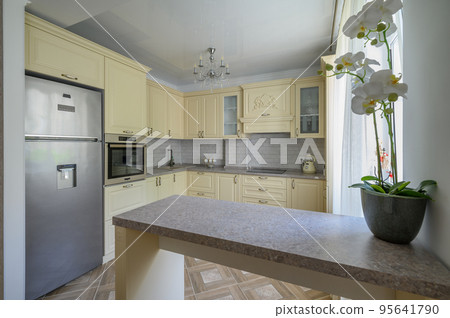 Interior of modern trendy cream colored kitchen Interior of modern trendy cream colored kitchen 95641790