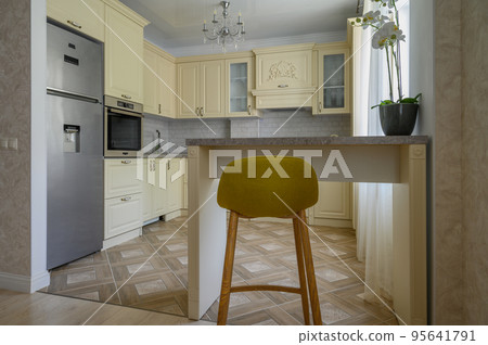 Interior of modern trendy cream colored kitchen Interior of modern trendy cream colored kitchen 95641791