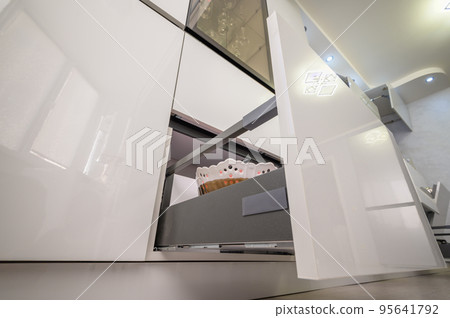 Closeup to furniture details of modern trendy white kitchen Closeup to furniture details of modern trendy white kitchen 95641792