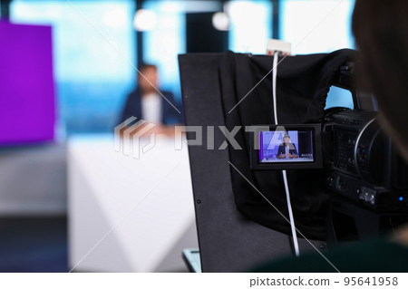 Presenter and video camera operator working in studio. News broadcasting 95641958