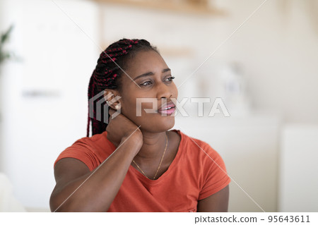 Closeup Portrait Of Dreamy Young African American Woman Relaxing At Home Closeup Portrait Of Dreamy Young African American Woman Relaxing At Home 95643611