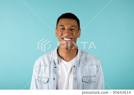 Portrait of happy attractive millennial african american guy in jeans look at camera Portrait of happy attractive millennial african american guy in jeans look at camera 95643614