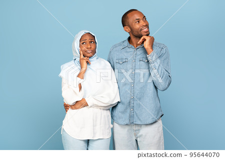 African American Couple Posing Dreaming And Thinking On Yellow Background 95644070