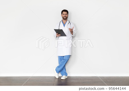 Portrait Of Handsome Male Doctor In Uniform With Clipboard In Hands 95644144