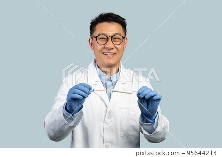 Cheerful mature chinese man doctor in glasses and protective gloves use covid-19 test Cheerful mature chinese man doctor in glasses and protective gloves use covid-19 test 95644213