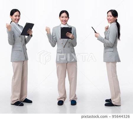 Full Length 20s Asian Woman wear formal business blazer suit  dress pant shoes. Black long straight hair female hold tablet work confident, walking forward turn left right, white background isolated 95644326