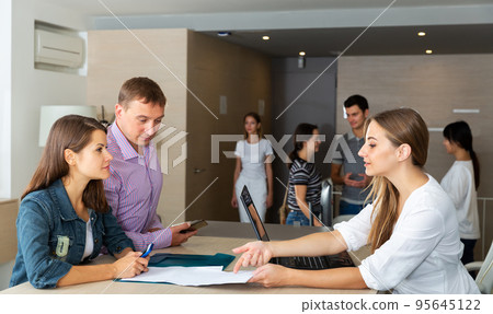 Male and female managers having meeting Male and female managers having meeting 95645122