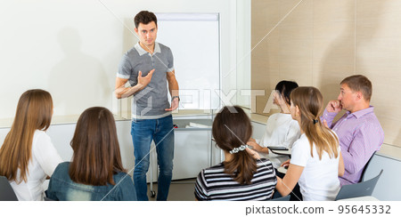 Young man presenting business strategy to team Young man presenting business strategy to team 95645332