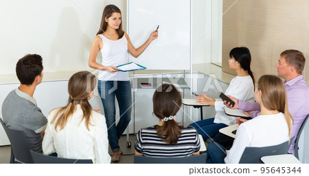 Female business coach communicating with auditorium 95645344