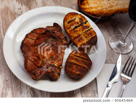 Image of grilled pork with potatoes served at plate Image of grilled pork with potatoes served at plate 95645464