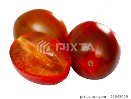 Closeup of fresh cherry kumato tomatoes with chopped slices 95645469