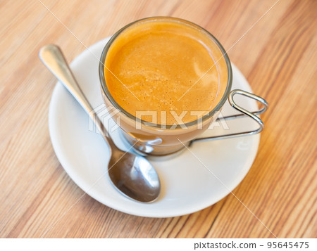 Mug of cortado served on table in cafe 95645475