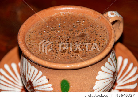 Traditional hot chocolate in a clay mug Traditional hot chocolate in a clay mug 95646327
