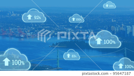 Composite of numbers with percentage and up arrow signs in clouds over aerial view of cityscape 95647187