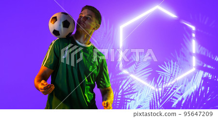 Caucasian player balancing ball on shoulder by illuminated plants and hexagon on purple background 95647209