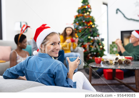 Image of happy caucasian woman celebrating christmas at home with friends drinking hot chocolate Image of happy caucasian woman celebrating christmas at home with friends drinking hot chocolate 95649085