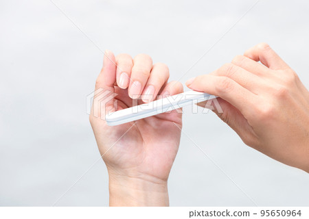 Woman's hands doing nail care Woman's hands doing nail care 95650964