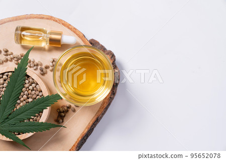 Set of legalized marijuana products displayed on a wooden plate. 95652078