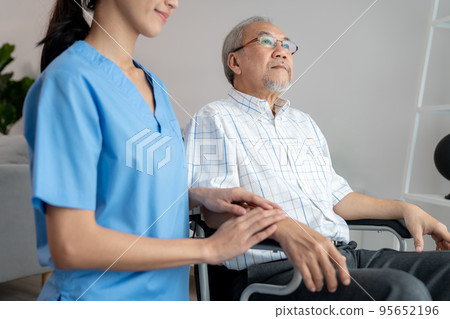 Caring nurse and a contented senior man in a wheel chair at home. Caring nurse and a contented senior man in a wheel chair at home. 95652196