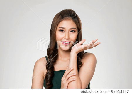 Portrait of ardent woman looking at camera, holding empty space for advertising. Portrait of ardent woman looking at camera, holding empty space for advertising. 95653127