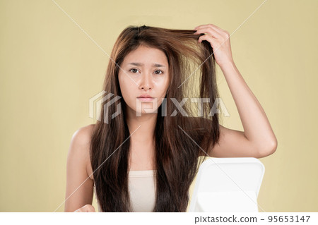 Ardent young girl feels insecure about her damaged hair. Ardent young girl feels insecure about her damaged hair. 95653147