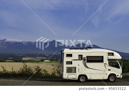 Camping car with Mt. Tokachi in the background at the Biei campsite Camping car with Mt. Tokachi in the background at the Biei campsite 95653522