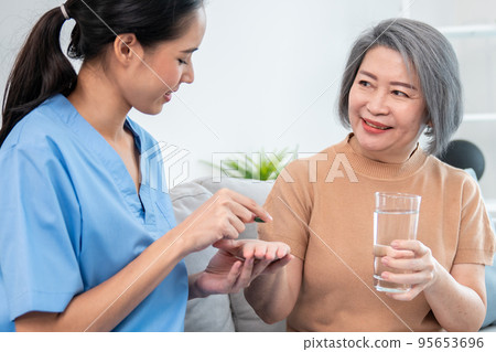 A contented senior woman taking medicine. 95653696