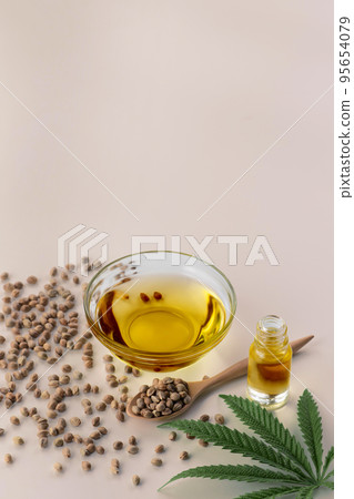 Legalized marijuana concept CBD oil in glass bowl and bottle with dropper lid. 95654079