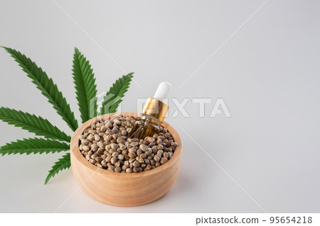 Hemp seeds with green sativa hemp leaf on top. Legalized marijuana concept. 95654218