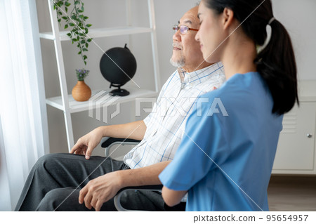 Caring nurse and a contented senior man in a wheel chair at home. Caring nurse and a contented senior man in a wheel chair at home. 95654957