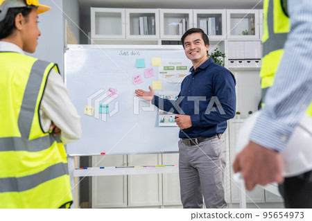 Entrepreneur brainstorming ideas with his competent engineers in the office. Entrepreneur brainstorming ideas with his competent engineers in the office. 95654973